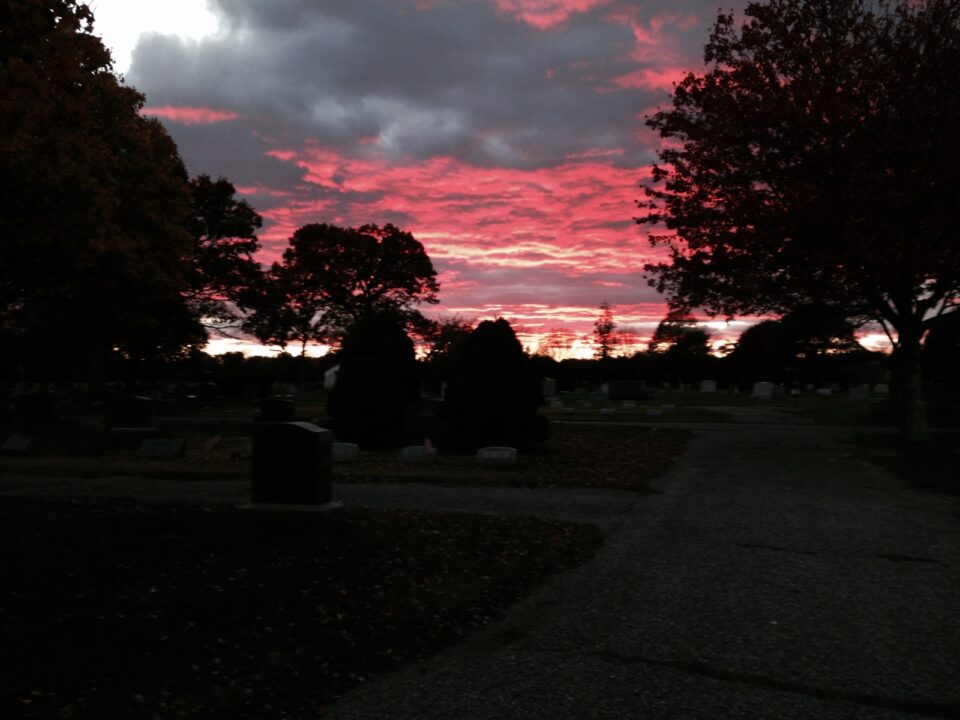 cemetery at dusk with red sky